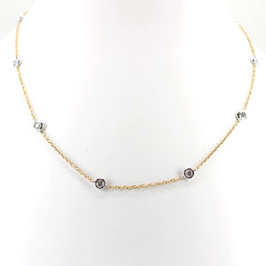 14 karat yellow gold necklace set with 10 round diamonds .73 Cttw